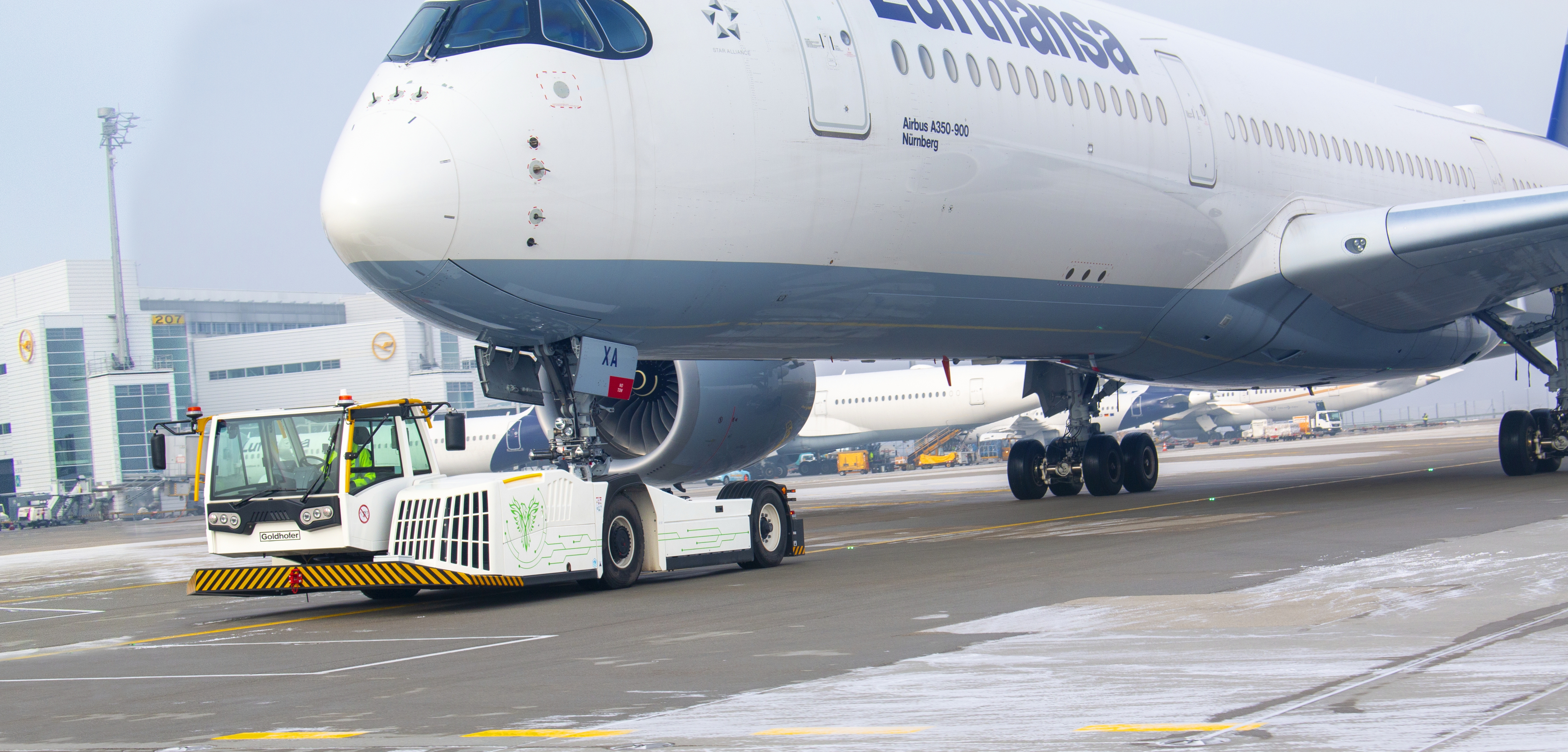 The electrified aircraft tractor pulls an Airbus A350-900